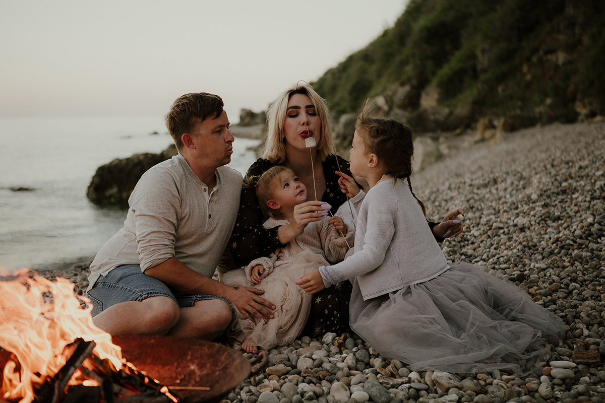 Family firepit beach toasting marshmallows